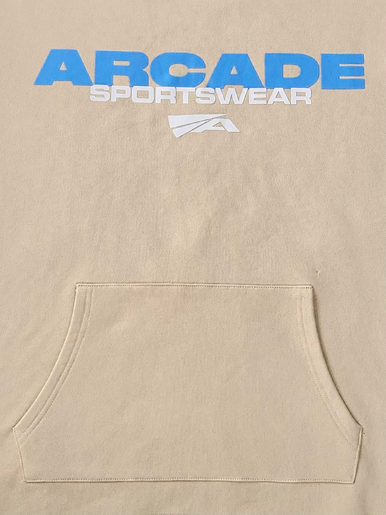 Arcade Sportswear Hoodie Tan Features: Screen printed “Arcade Sportswear” Graphic w/ logo on chest Heavyweight 420 GSM 100% French Terry Cotton Oversized loose fit Semi-cropped w/ drop shoulders Adjustable cord lock on waist