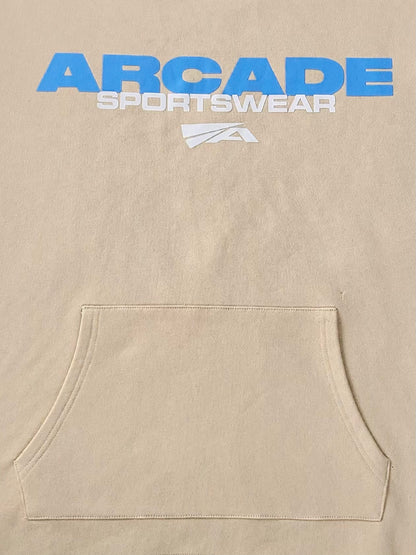 Arcade Sportswear Hoodie Tan Features: Screen printed “Arcade Sportswear” Graphic w/ logo on chest Heavyweight 420 GSM 100% French Terry Cotton Oversized loose fit Semi-cropped w/ drop shoulders Adjustable cord lock on waist